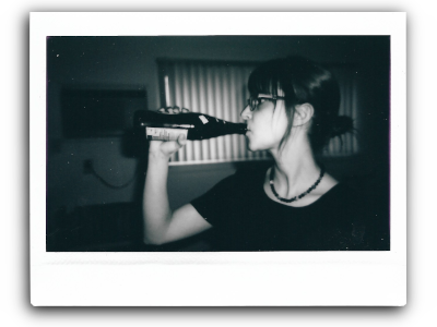 a bw instant picture of m drinking a big beer