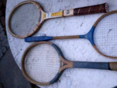 tennis and badminton racket lying on a white table