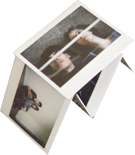 a house of cards built with instant photos of m and me